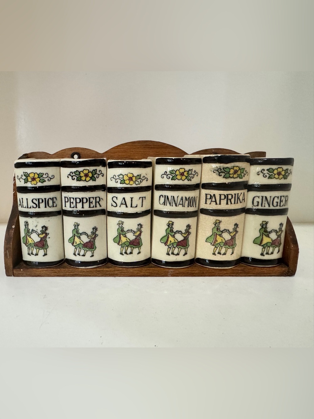 Vintage black and cream dancing man and woman spice jars with floral motif.